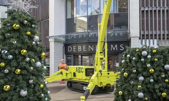 Our team installing large Christmas trees outside a department store